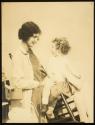 [Woman (model Ruth Malcomson) with a one-shoed toddler on lap]