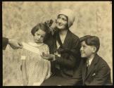 [Woman (model Ruth Malcomson) with two young children, receiving check]