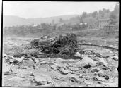Engine buried in Drift. Thirty freight locomotives from destroyed round house at Conemaugh, rolled down the Conemaugh River, totally destroyed and buried in drift.