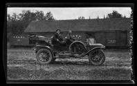 [Dr. Ernst Wilkens, chauffeur, in open touring car]