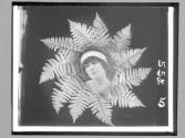 [Woman's Face In Ferns]