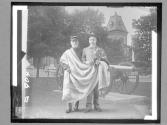 [Two American war veterans draped in American flag]