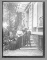[Portrait of a group beside a house]
