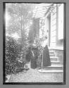 [People standing near a house]