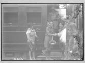 [Mrs. Martin Johnson, American Boy Scout Dick Douglas shakes hands with Martin Johnson, African scout stands in train, American scout Douglas R. Martin (laughing), David R. Martin (hat in hand) at Nairobi Train Station

]