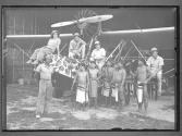 [Martin and Osa Johnson with their amphibious plane, crew members and natives of Borneo]