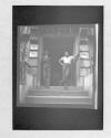 Two men in doorway of Rooming House