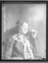 [Woman in costume, smoking a cigarette]