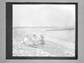 [Fisher Women Sitting By Lake]
