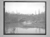 [Boat Passing Under Stone Bridge]