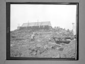 [People And Architecture In Rocky Landscape]
