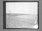 [Female Walking Along Beach Shore]