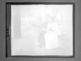 [Gertrude G. Fisher and woman sitting on hammock]