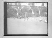 [People And Pidgeons In Front Of Arched Architecture]