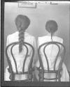 [Two seated women, from behind]