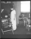 [Woman (C.L.F.) in kitchen]