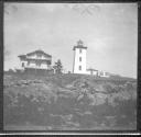 [Lighthouse and Rocky Shoreline]