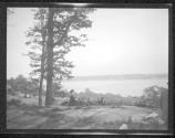 [Marine view (pond or lake) with woman sitting on hill]