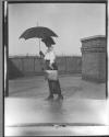 [Laura M. Fisher On Roof With Umbrella]