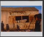 Children stand near their house, in the unrecognized Bedouin village of Abu Ajaj