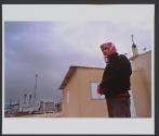 Ahmad Jarjawee stands near the mosque of the unrecognized Bedouin village of Wadi El Na'am, residing near a power station