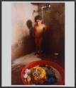 A child takes a shower under a tap, in the unrecognized Bedouin village of Abu Ajaj