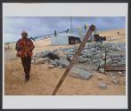 A member of the Zanoon family walks by the family's demolished house, in the unrecognized Bedouin village of Wadi El Na'am