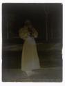 [Woman holding cat on sidewalk]