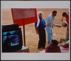 A kid watches a movie about his tribe's exile, at a protest tent in the tribe's historical land of El Arakib.