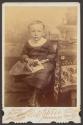 [Little boy holding a photograph]