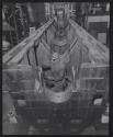 [Welder working inside a large piece of machinery]