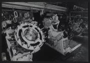 [Worker assembling a large piece of industrial equipment]