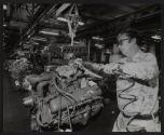 [Worker assembling engine for USPS, DJ-5 jeeps]