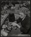 [Worker assembling engine for DJ-5 jeep on production line]