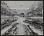 [Technician holding trays of vacuum tubes in tube storage area.]