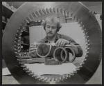 [Technician measuring gears with calipers]