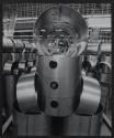 [Worker in ductwork factory]