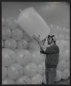 [Worker inspecting a plastic tank]