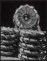 [Worker peers through the center of a metal impeller.]