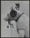 [Rooftop sculpture of "Nipper" being groomed by Barry La Point and George Luft]