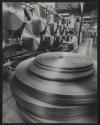 [Technician working on a ribbon spooling machine]