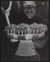 [Man working on a large molten metal object]