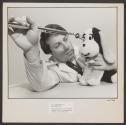 [Technician using a metal gauge to test the physical integrity of a stuffed toy.]
