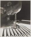 [Man examining a grayscsale transparency on a light table with a loupe]