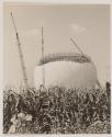 [Radar dome underconstruction behind a corn field]
