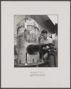[Technician adjusting clamps on a brazing chamber]