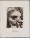 [Woman looking through magnifying glass at a micro-switch]