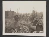 [German prisoners captured in Frankfurt, Germany bring rations across a bridge to infantryman of the 5th Division, 3rd US Army.  5th Div, TUSA, Frankfurt, Germany. ]