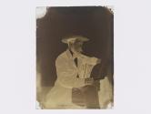 [Man reading newspaper]
