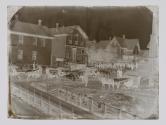 [Crowd and horse-drawn carriages in street]